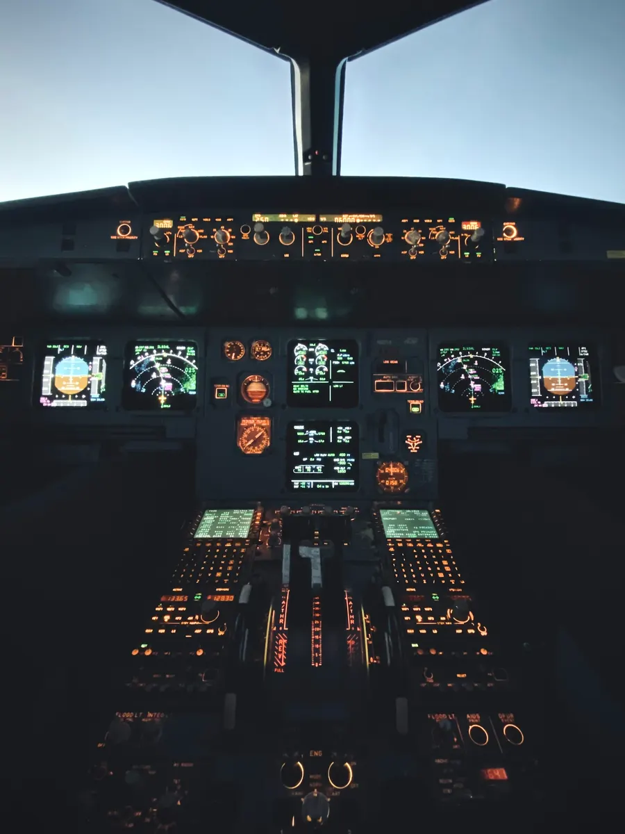 Airbus flight deck at dusk with illuminated panels