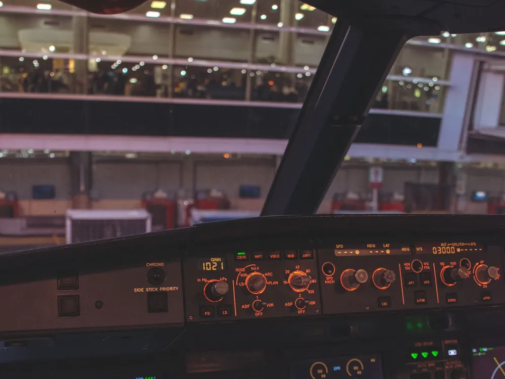 Night view from the flight deck across an airport apron